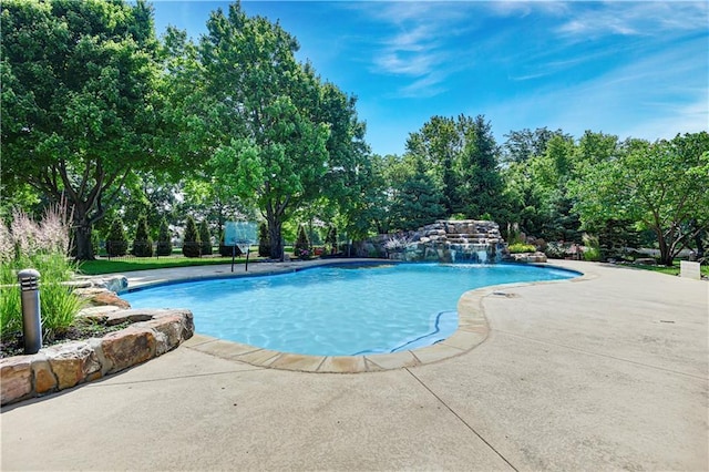 14575 Granada Cir, Leawood, KS 66224 - swimming pool with view of wooded area and a patio area