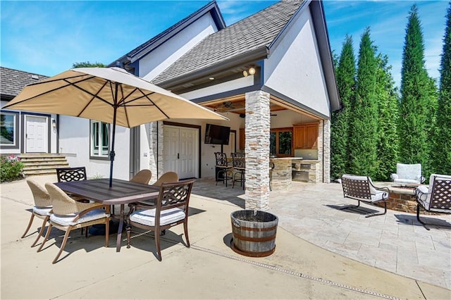 14575 Granada Cir, Leawood, KS 66224 - view of patio featuring ceiling fan, a fire pit, exterior bar, and outdoor dining space