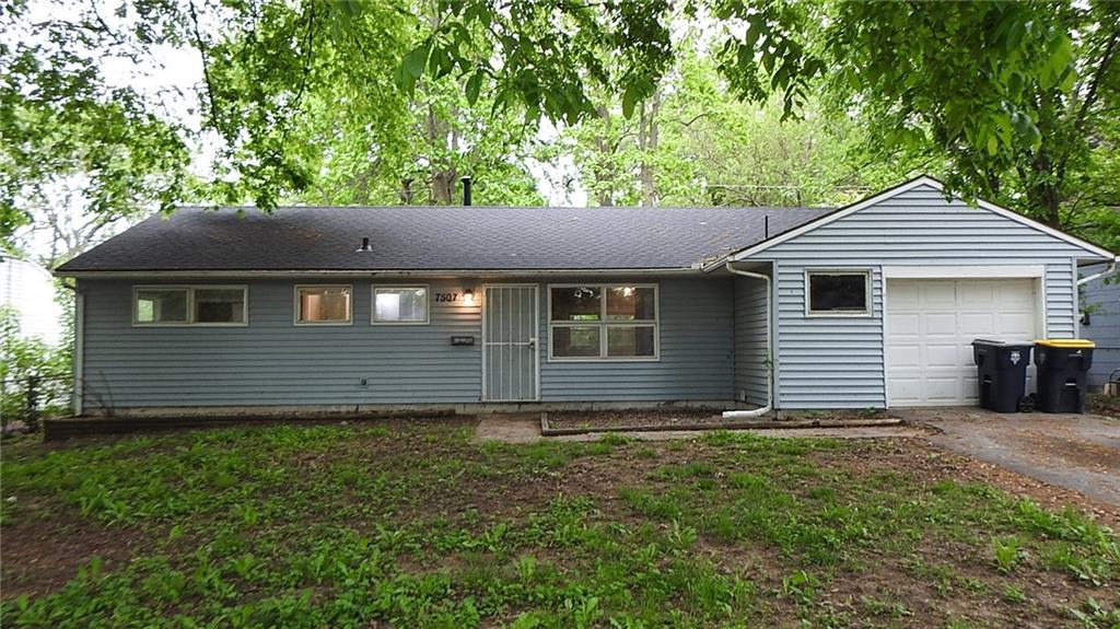 ranch-style home with concrete driveway and a garage