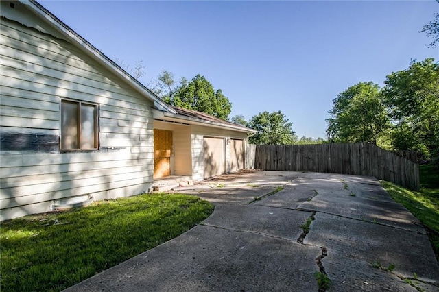 4904 Grandview Rd, Kansas City, MO 64137 - view of home's exterior featuring fence, an attached garage, and driveway