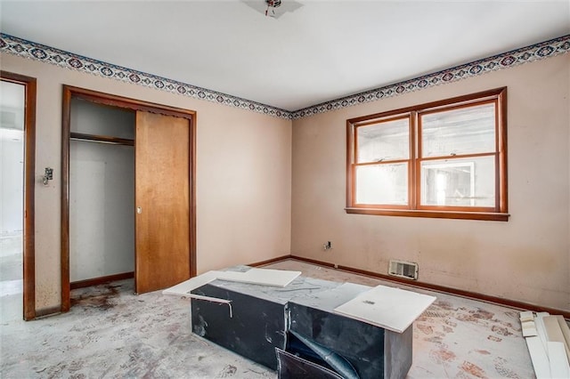 4904 Grandview Rd, Kansas City, MO 64137 - unfurnished bedroom featuring baseboards, baseboard heating, a closet, and visible vents