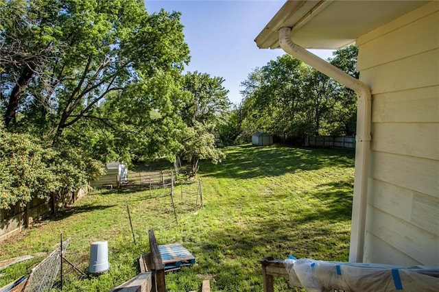 4904 Grandview Rd, Kansas City, MO 64137 - view of yard featuring a storage shed, fence, and an outdoor structure