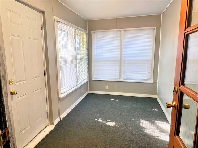 carpeted spare room with baseboards