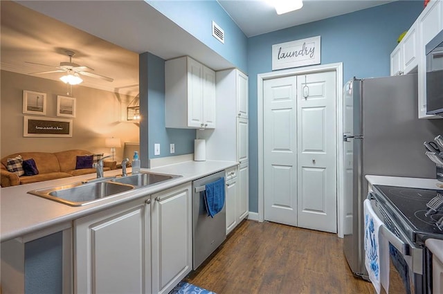 11629 Tomahawk Creek Pkwy Unit G, Leawood, KS 66211 - kitchen with a sink, appliances with stainless steel finishes, dark wood-style flooring, ceiling fan, and white cabinets