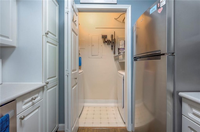 11629 Tomahawk Creek Pkwy Unit G, Leawood, KS 66211 - washroom with separate washer and dryer, baseboards, and tile patterned floors