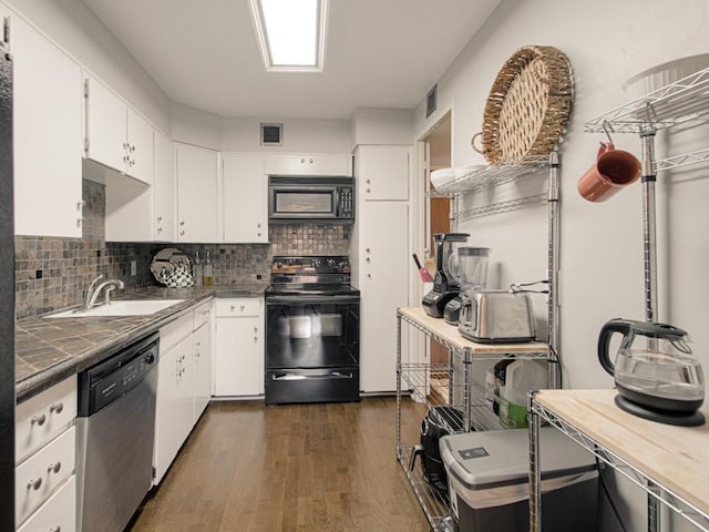 kitchen featuring black appliances, a sink, white cabinets, decorative backsplash, and dark wood finished floors