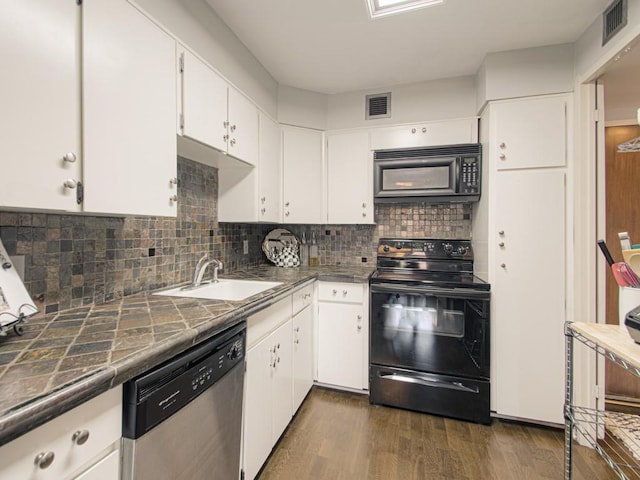 kitchen featuring black appliances, a sink, dark wood finished floors, white cabinetry, and tile counters