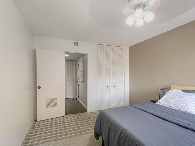 carpeted bedroom with a closet and ceiling fan