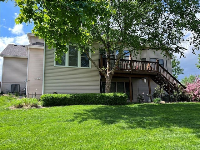 rear view of property featuring a yard, a deck, cooling unit, and stairs