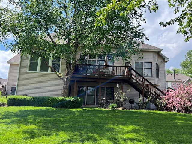 rear view of property featuring a lawn, a deck, and stairway