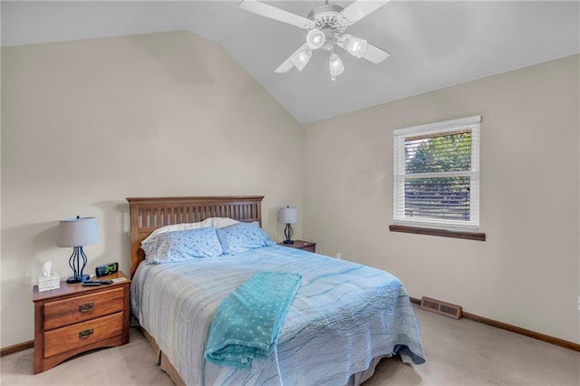 bedroom featuring light colored carpet, lofted ceiling, baseboards, and ceiling fan