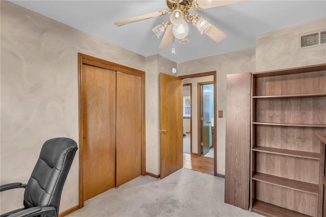 unfurnished office with ceiling fan and baseboards