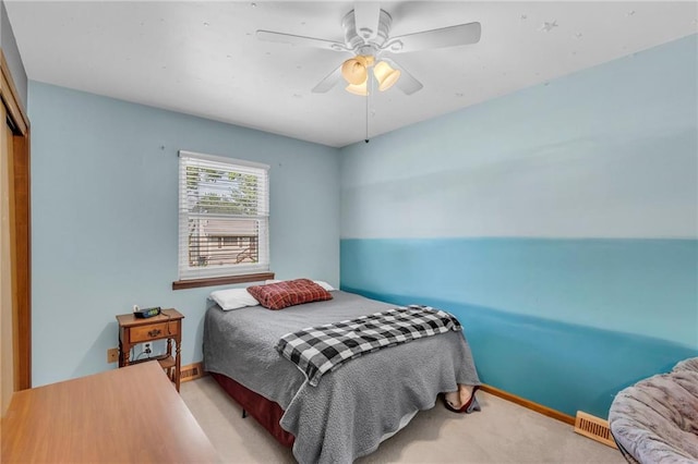 bedroom featuring carpet, ceiling fan, baseboards, and a closet