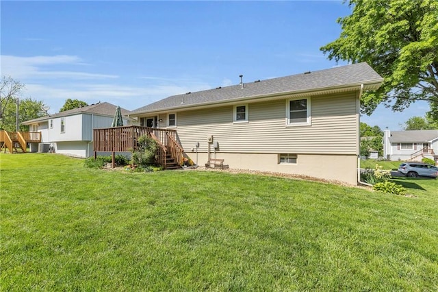 rear view of property featuring stairway, a deck, and a yard