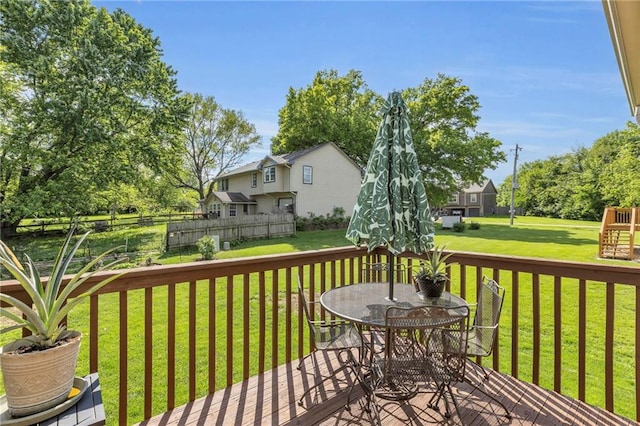 deck with outdoor dining area and a playground