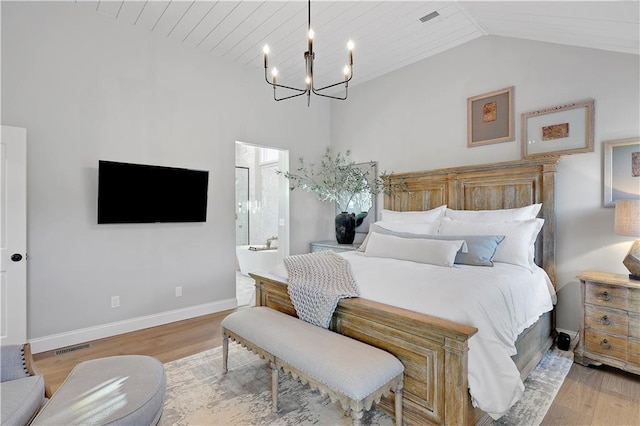 5918 Theden St, Shawnee, KS 66218 - bedroom with a chandelier, wood finished floors, lofted ceiling, baseboards, and ensuite bath