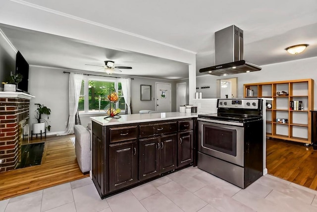 6138 Hadley St, Merriam, KS 66202 - kitchen with electric range, range hood, light countertops, a ceiling fan, and light tile patterned floors