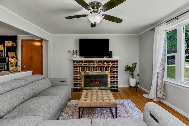 6138 Hadley St, Merriam, KS 66202 - living area featuring wood finished floors, healthy amount of natural light, baseboards, a ceiling fan, and crown molding