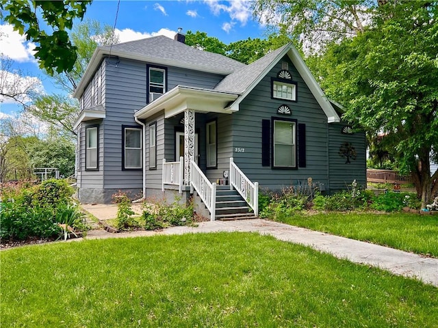 2312 Maple Ave, Leavenworth, KS 66048 - view of front of house featuring a front yard, a chimney, and roof with shingles