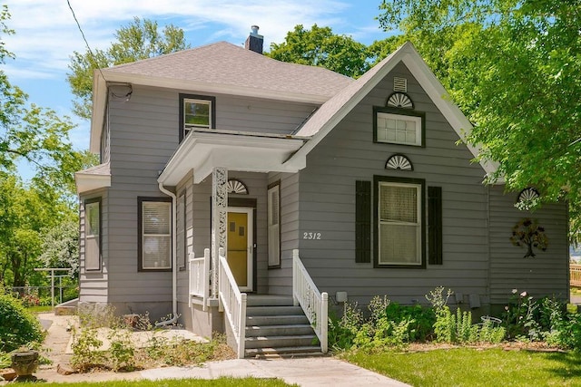 2312 Maple Ave, Leavenworth, KS 66048 - view of front of house with a chimney and a shingled roof