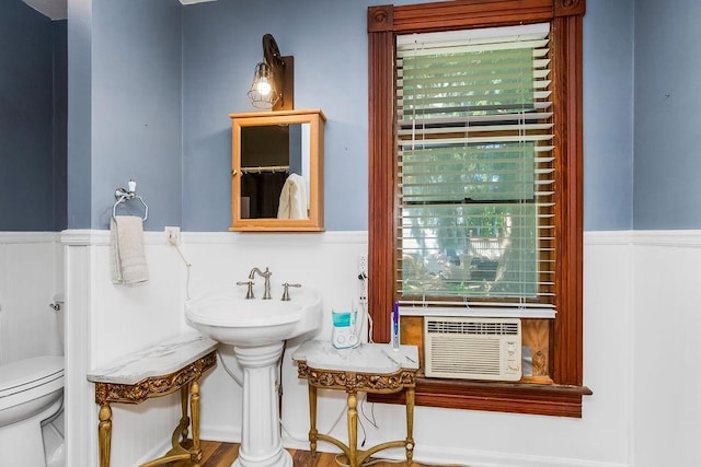 2312 Maple Ave, Leavenworth, KS 66048 - bathroom with a wainscoted wall, toilet, a sink, and cooling unit