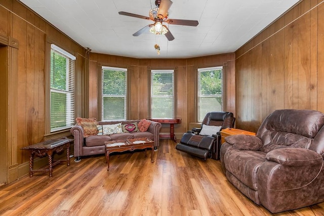 2312 Maple Ave, Leavenworth, KS 66048 - living area with ceiling fan, light wood finished floors, and wooden walls