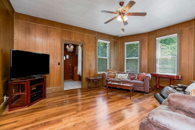 2312 Maple Ave, Leavenworth, KS 66048 - living area with plenty of natural light, ceiling fan, wooden walls, and light wood-style floors
