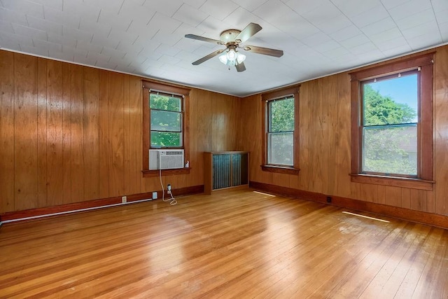 2312 Maple Ave, Leavenworth, KS 66048 - empty room with light wood finished floors, ceiling fan, wooden walls, and cooling unit