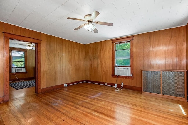 2312 Maple Ave, Leavenworth, KS 66048 - spare room featuring ceiling fan, wood finished floors, cooling unit, and wooden walls