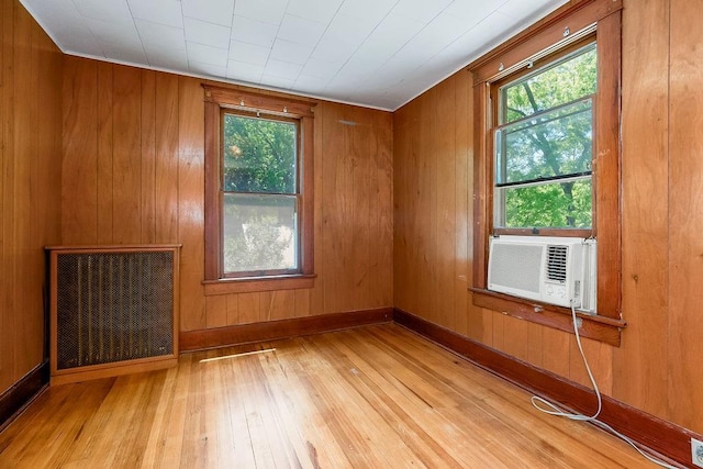 2312 Maple Ave, Leavenworth, KS 66048 - spare room with hardwood / wood-style flooring, cooling unit, and wooden walls