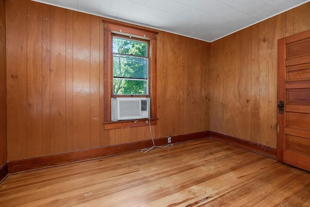 2312 Maple Ave, Leavenworth, KS 66048 - empty room featuring wood finished floors, wooden walls, cooling unit, and baseboards