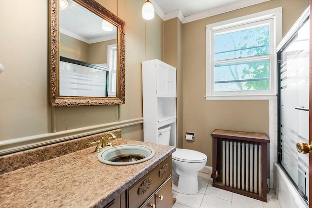 2312 Maple Ave, Leavenworth, KS 66048 - bathroom featuring radiator heating unit, ornamental molding, vanity, toilet, and tile patterned floors