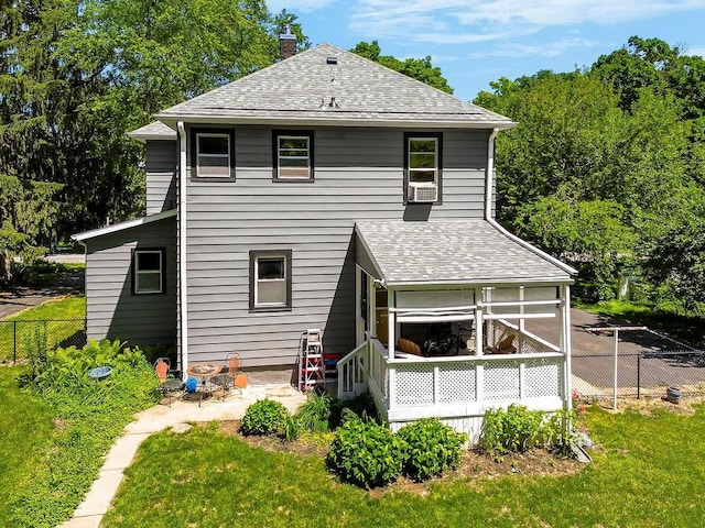 2312 Maple Ave, Leavenworth, KS 66048 - rear view of property with a shingled roof, a chimney, and a sunroom