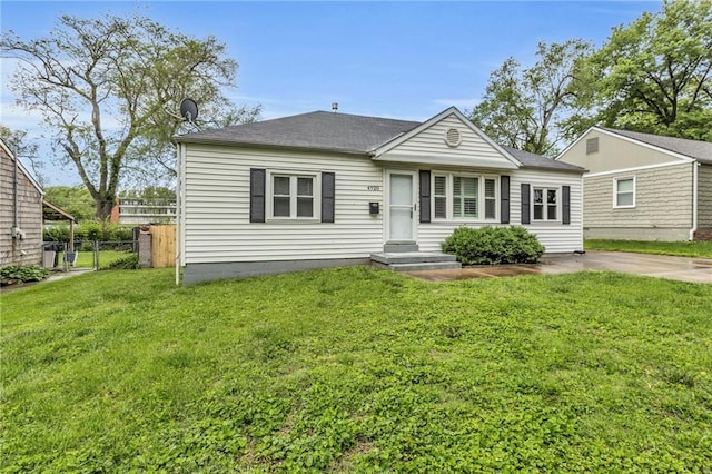 bungalow-style home with fence and a front yard