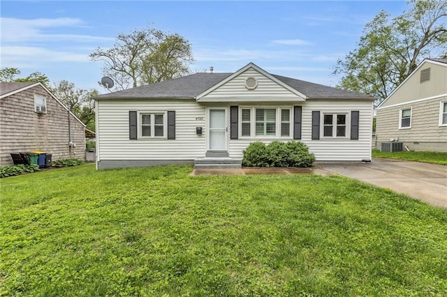 bungalow featuring central air condition unit and a front lawn