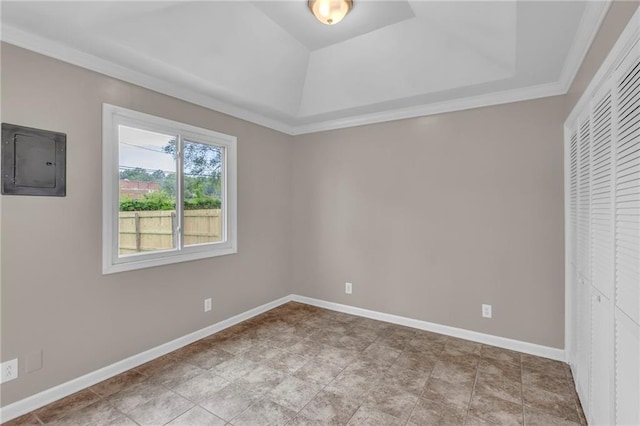 unfurnished bedroom with a raised ceiling, baseboards, electric panel, and a closet