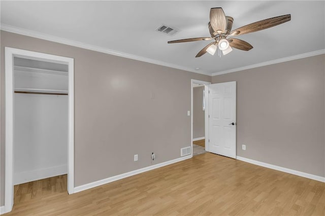 unfurnished bedroom featuring baseboards, light wood-type flooring, and visible vents