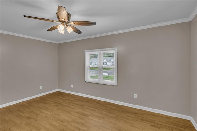 unfurnished room with baseboards, a ceiling fan, light wood finished floors, and crown molding