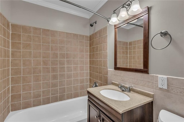 bathroom featuring vanity, ornamental molding, toilet, tile walls, and shower / washtub combination