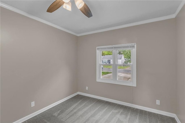 empty room featuring baseboards, ornamental molding, carpet, and a ceiling fan