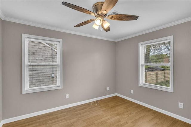 spare room featuring baseboards, plenty of natural light, and light wood-style flooring