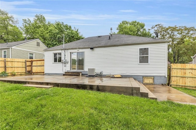 back of house with a lawn, a wooden deck, a fenced backyard, and central air condition unit