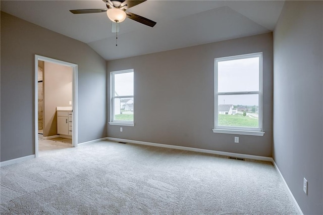 unfurnished bedroom with baseboards, light colored carpet, and multiple windows