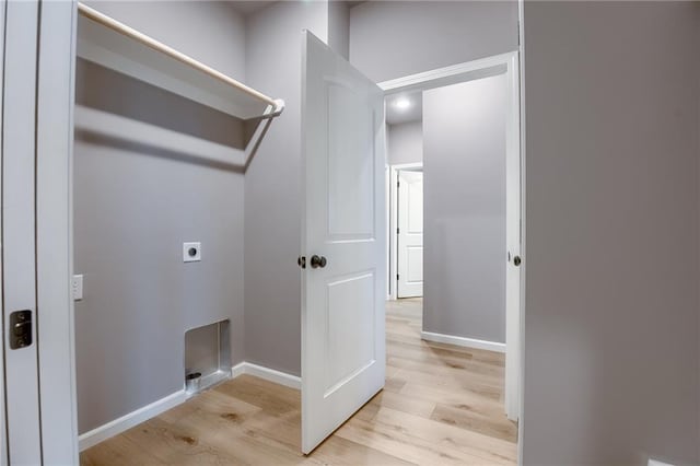 laundry room featuring baseboards, hookup for an electric dryer, light wood-style flooring, and laundry area