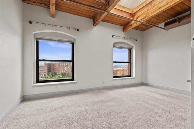 carpeted spare room with baseboards, wooden ceiling, and beam ceiling