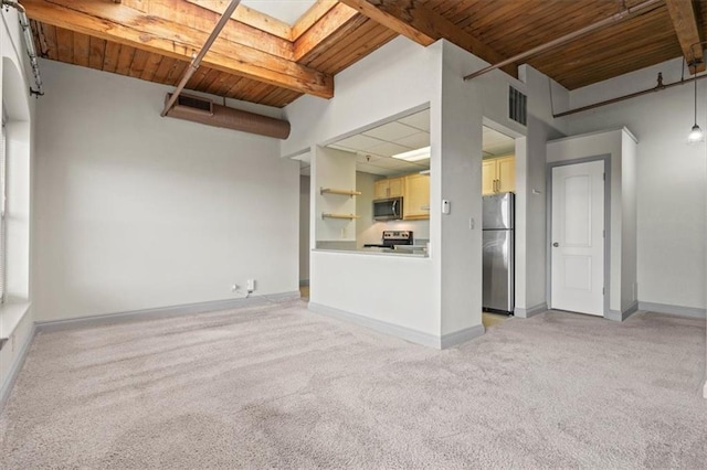 unfurnished living room featuring light colored carpet, wood ceiling, visible vents, and beamed ceiling