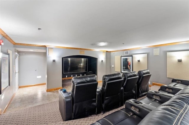 home theater room featuring baseboards, visible vents, and ornamental molding