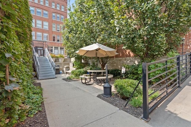 view of community with stairs and a patio area