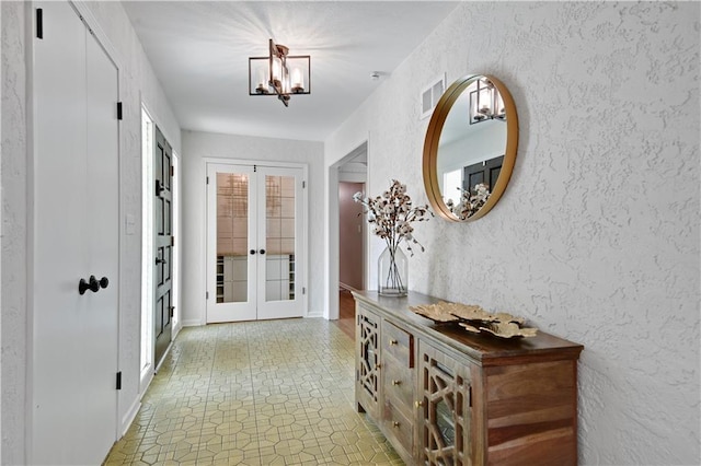 doorway to outside featuring french doors and light floors
