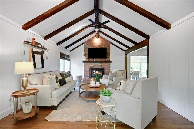 living room with a fireplace, wood finished floors, and ceiling fan